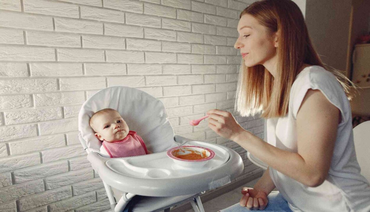 Mom feeding her baby with feeding essentials